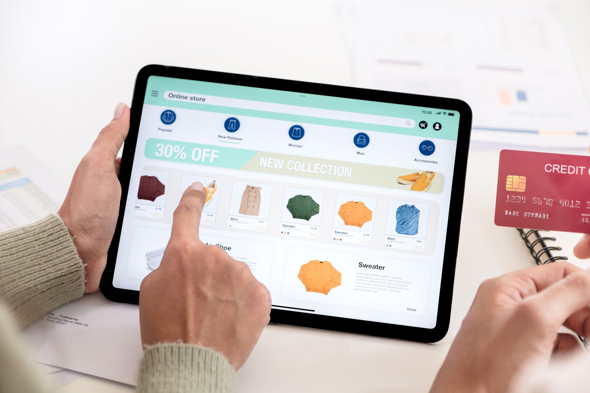 Couple using tablet and credit card to shop online through e-commerce app, making payment and browsing modern platform with promo codes and discount offers